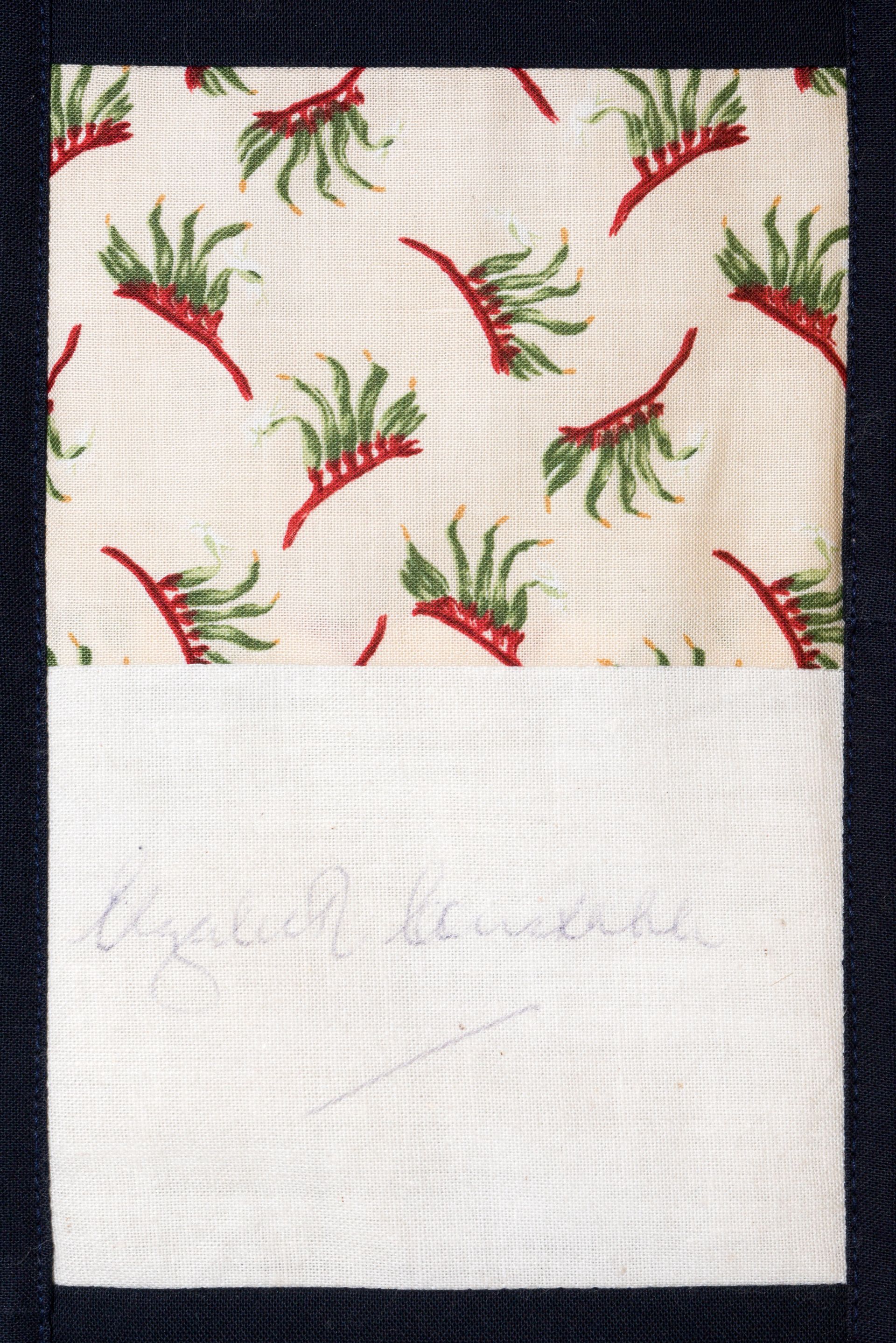 White notebook page with a patterned red-and-green print at the top and faint pencil writing below.