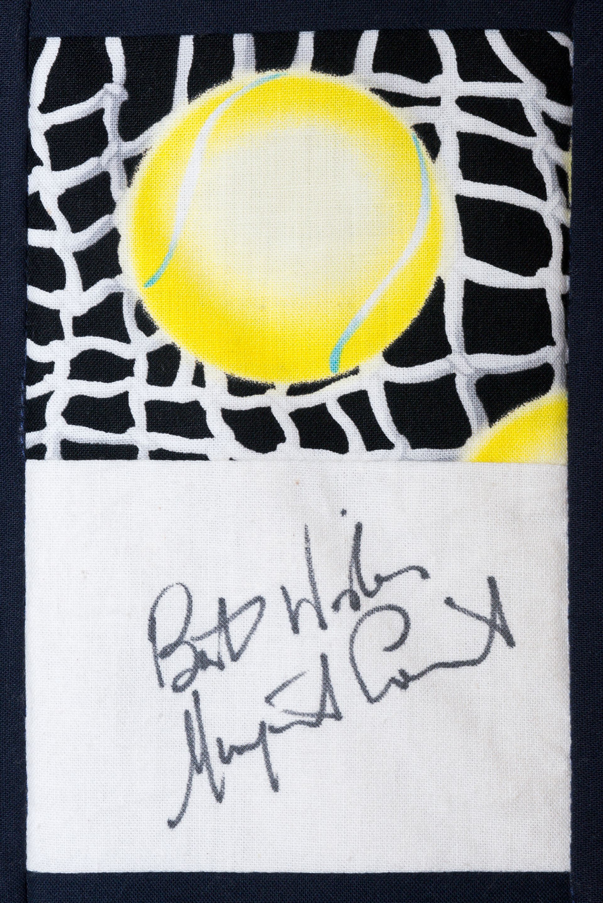 Black-and-white patterned fabric with a yellow circle and a small paper note with handwritten text