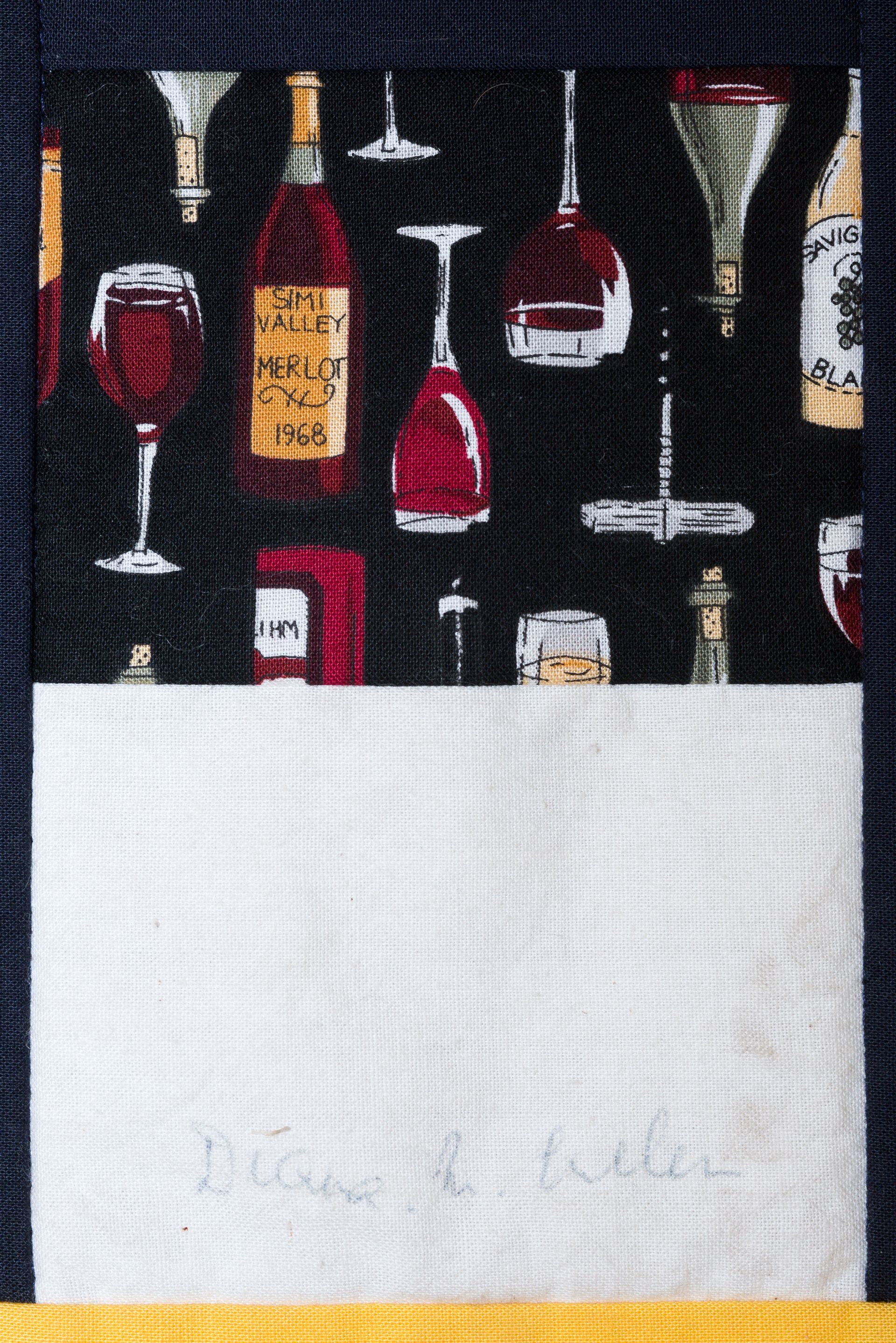 Bottles and wine glasses on a dark background above a blank white label area