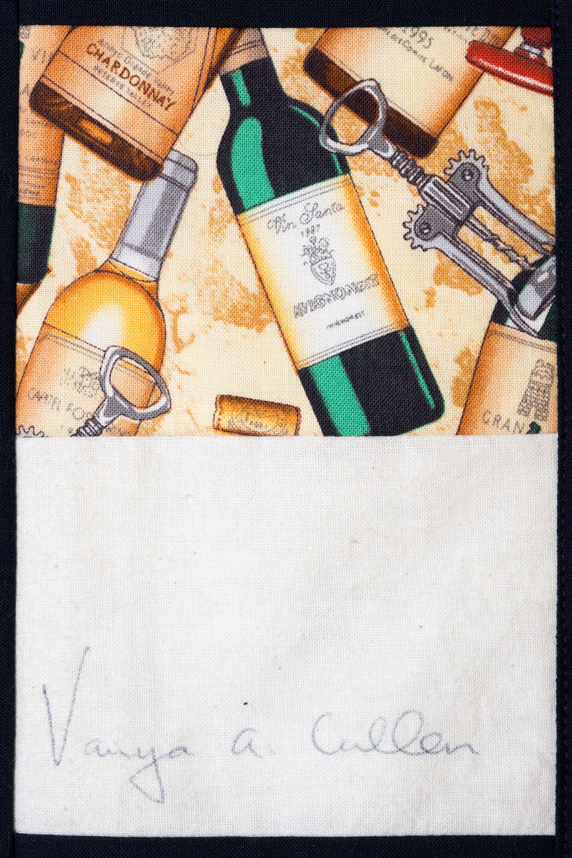 Assorted liquor bottles on a wooden surface above a blank white label area