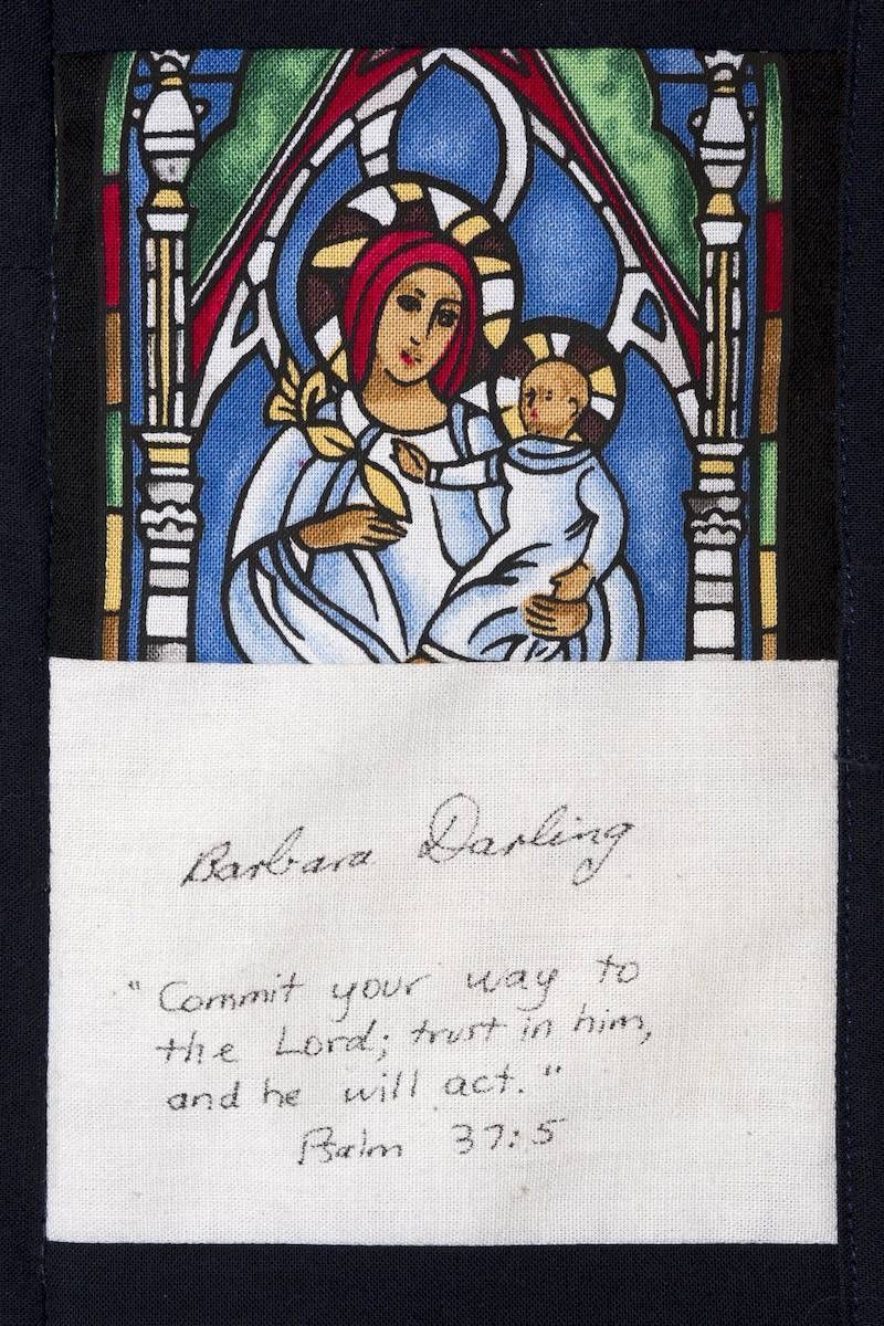 Nativity stained-glass window above a handwritten prayer note