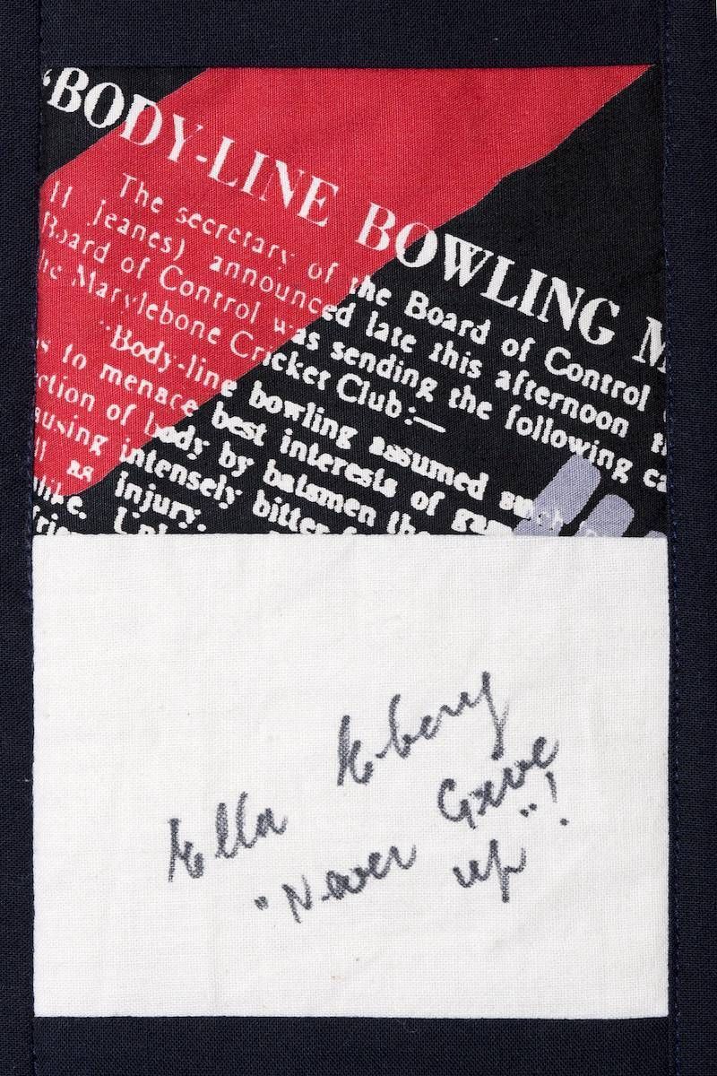 Handwritten note on white card over a black and red printed background.