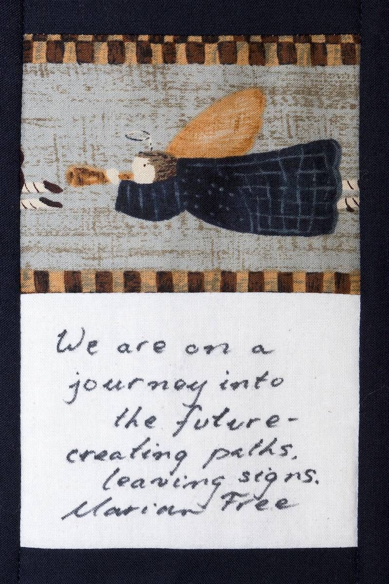 Woven wall hanging with a bird and handwritten quote: “We are on a journey into the future.”