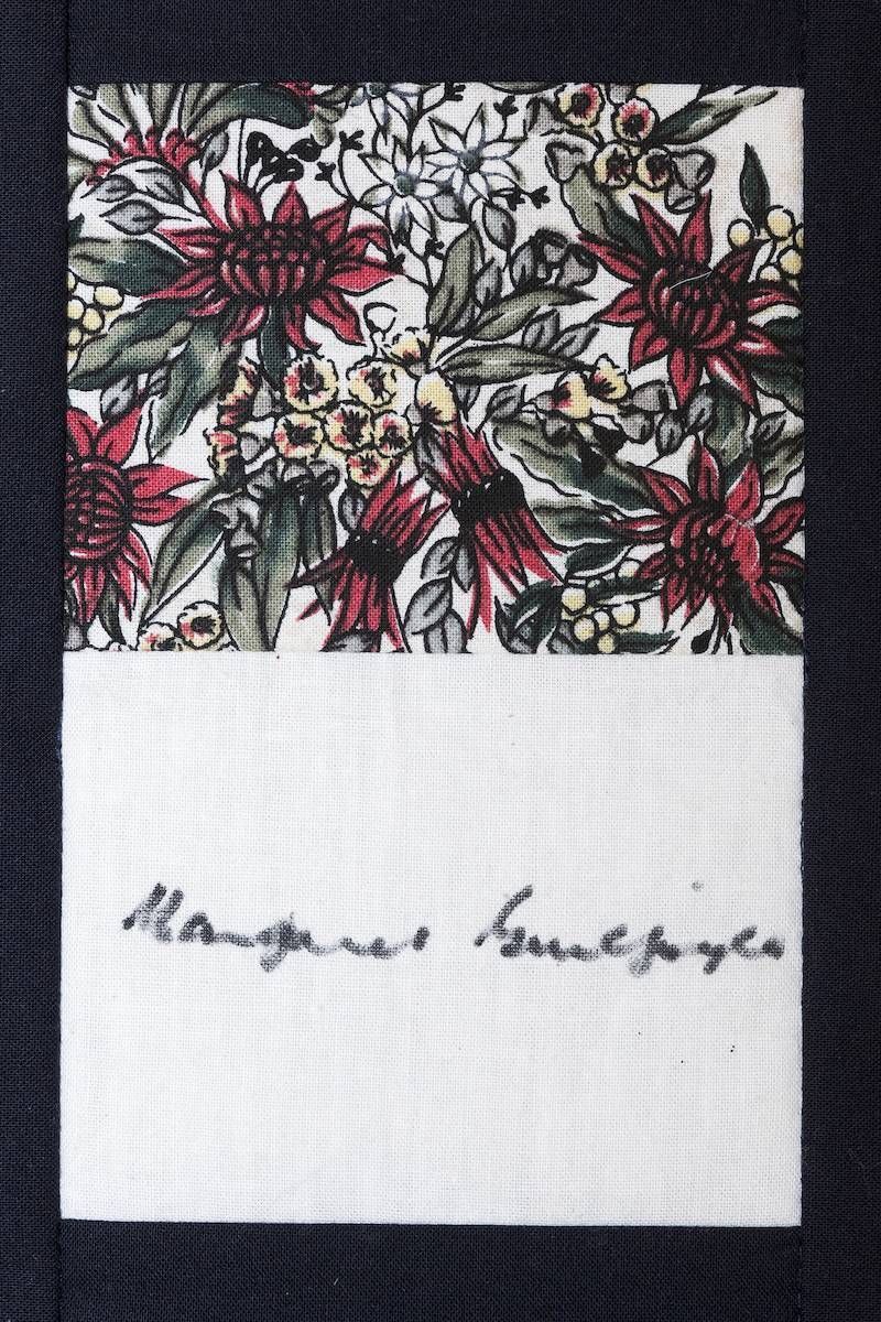 Floral fabric swatch above a signed white card with handwritten text