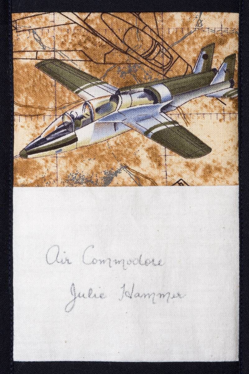Hand-drawn airplane illustration above handwritten signature on lined paper