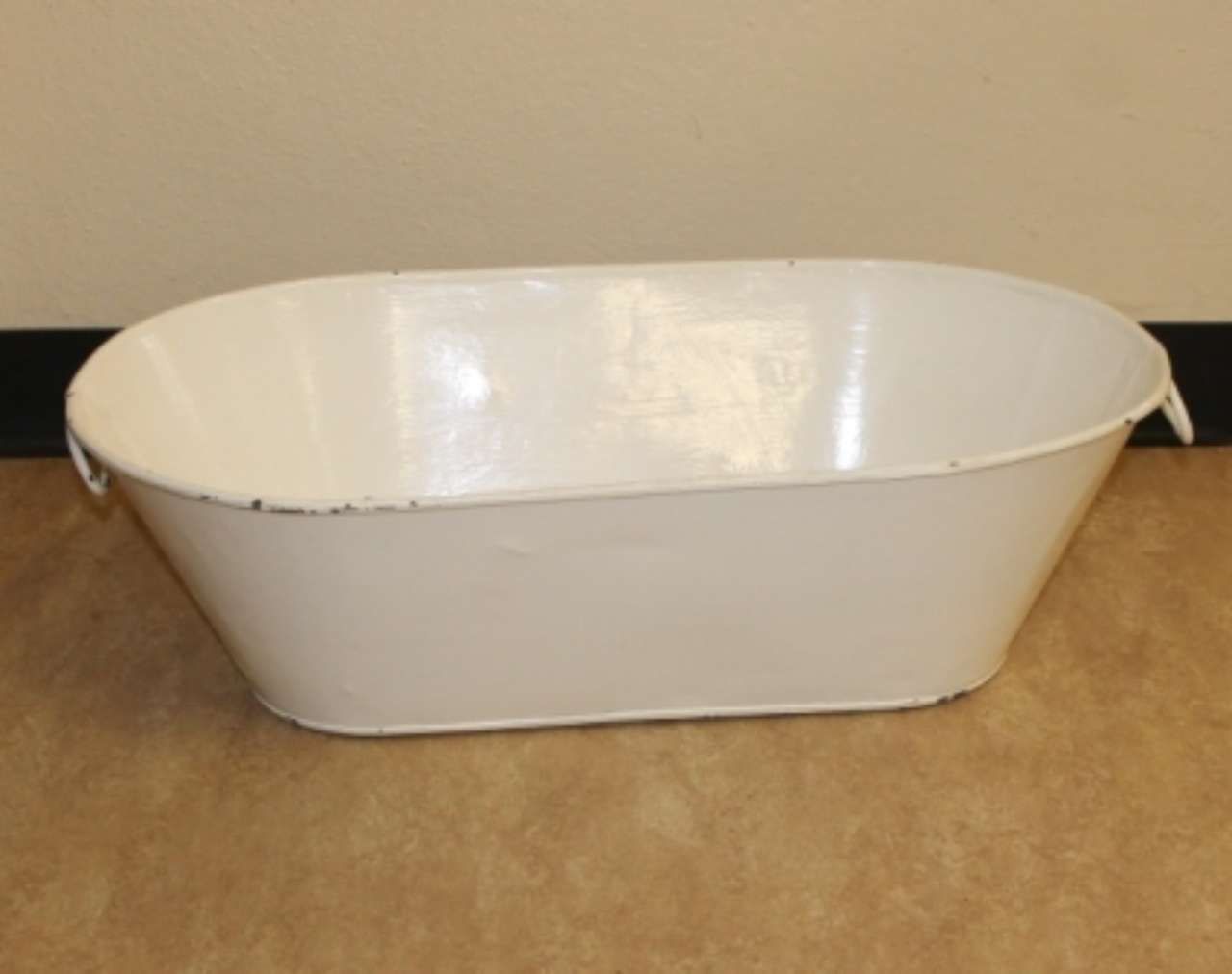 White oval plastic tub on a beige carpet