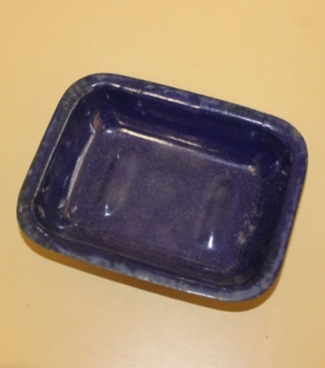 Blue rectangular plastic tray on a beige surface
