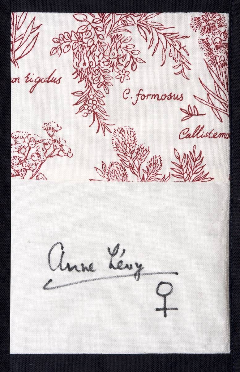 Signed note on white paper with red floral design and handwritten text.
