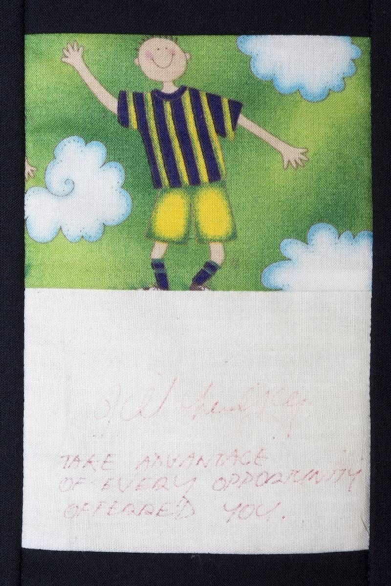 Illustrated soccer player in yellow and black jersey under clouds, with blank white space below.