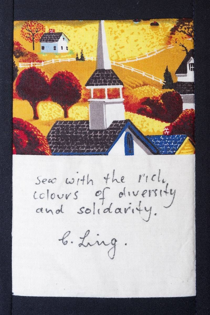 Handwritten note below colorful painting of a church and landscape: “seek with the gift of diversity and solidarity. E. Ling.”