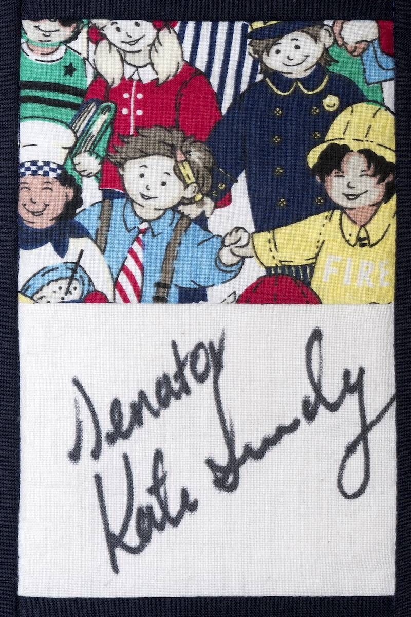 Signed card with cartoon children illustration and handwritten autograph on white paper