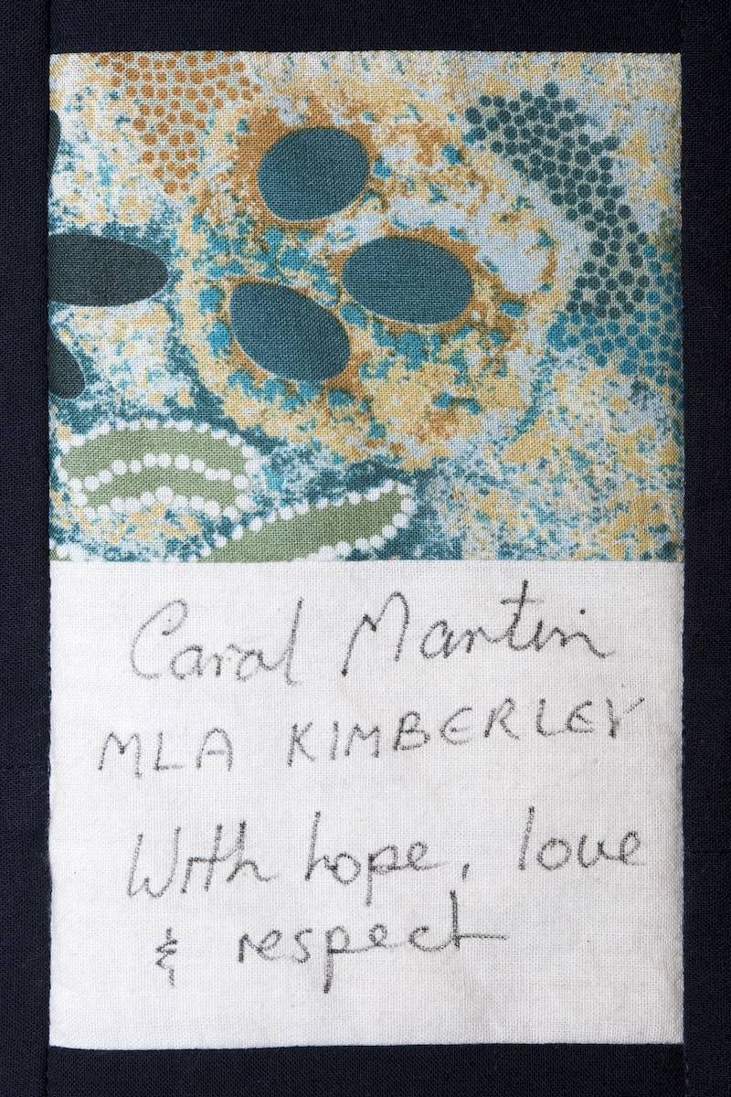 Handwritten note signed “Carol Martin” with “M.L.A. Kimberly” and “With hope, love & respect” beside a patterned fabric square