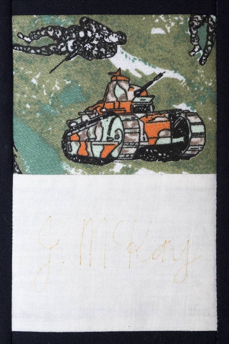 Orange tank under a dark cloud in a grassy field, with a blank white space below.