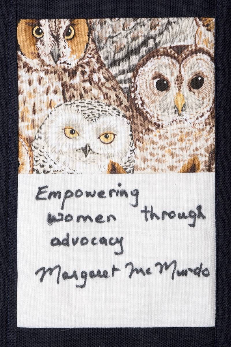 Owl artwork with handwritten quote “Empowering women through advocacy” and signature “Margaret Mvondo”