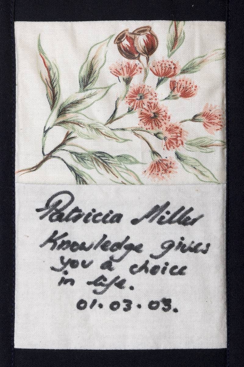 Handwritten note beside a small floral drawing with pink-red blossoms and green leaves on white paper.