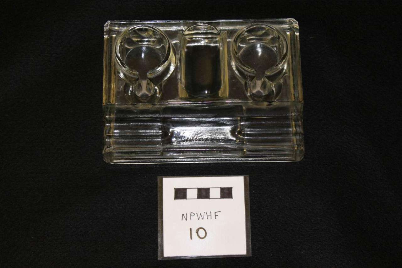 Clear plastic cassette tape case on black background with a small label reading “10” below it