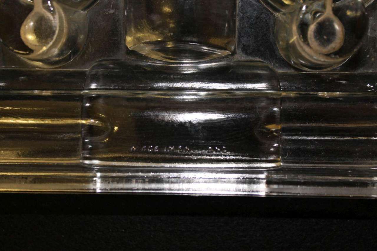 Close-up of a shiny chrome car bumper with reflections and a central license plate area