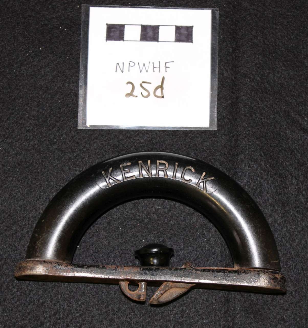 Black metal handle labeled 