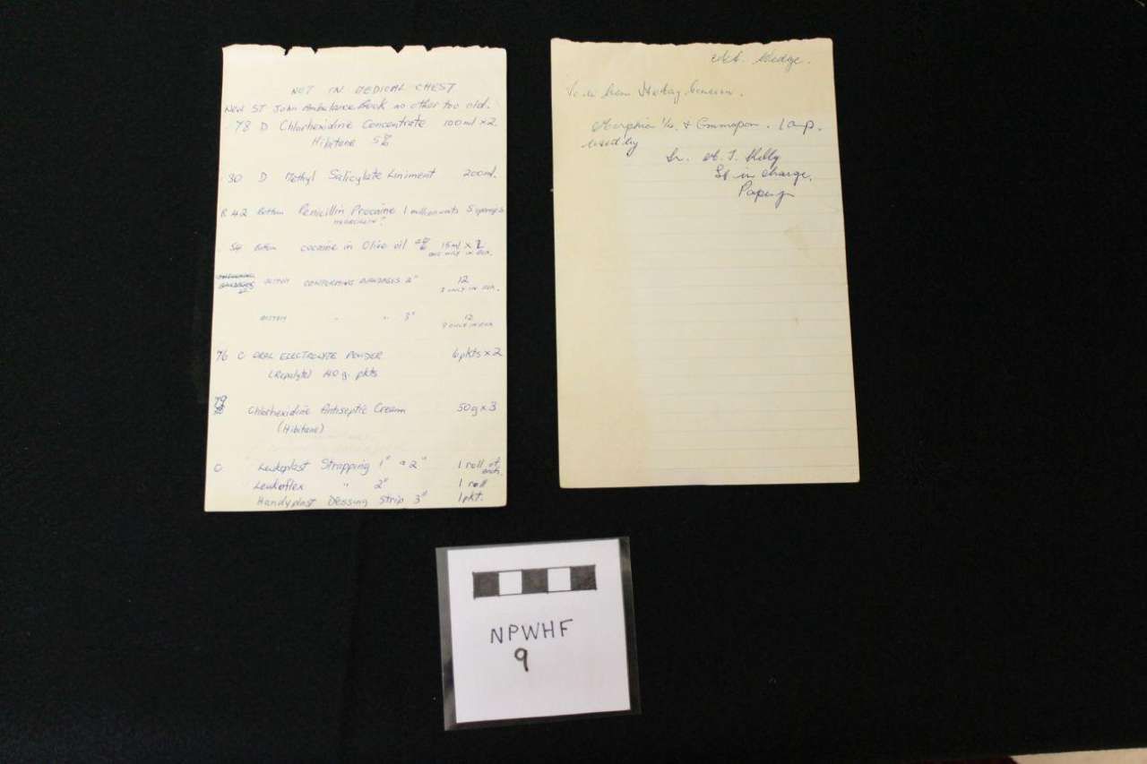 Three handwritten notes on a dark surface, two large pages above a smaller note below.