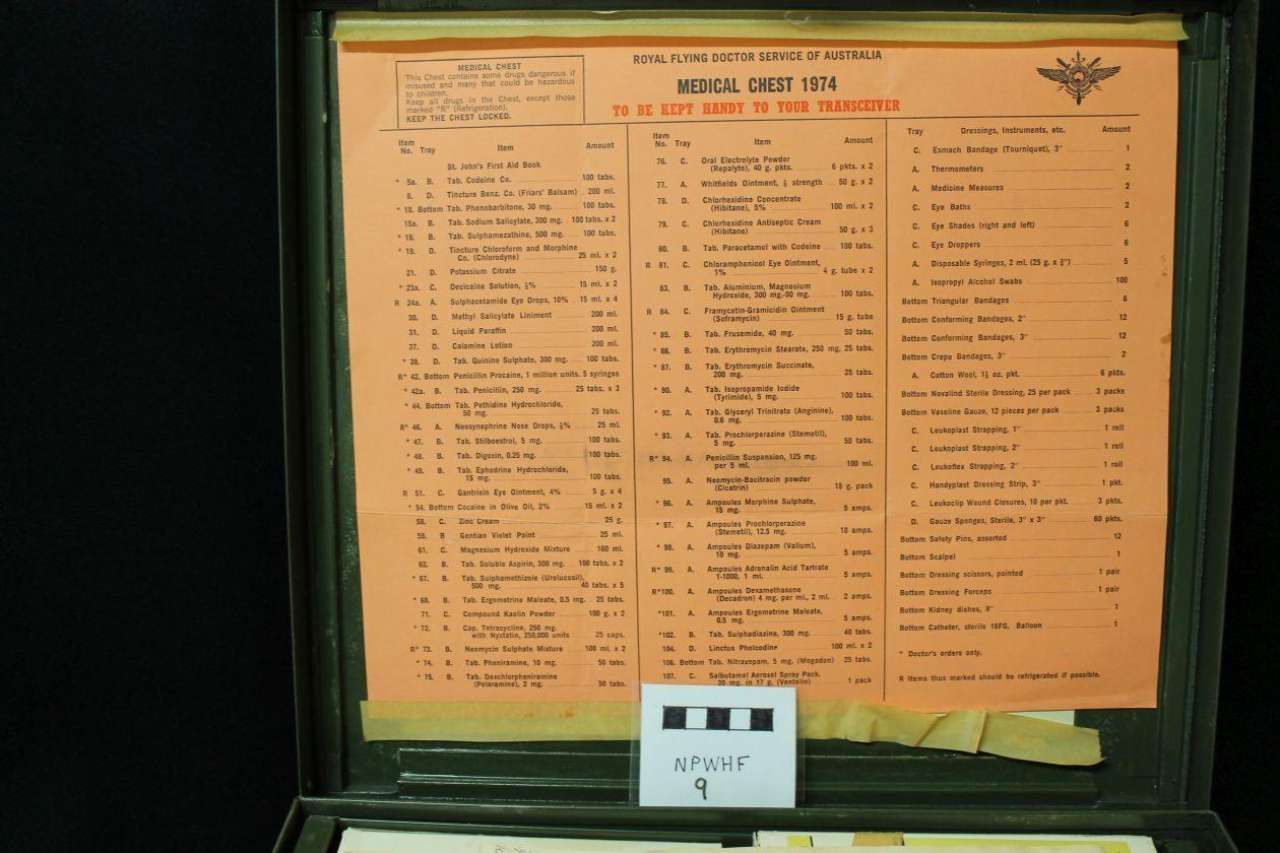 Orange menu board with multiple columns of small text behind glass, in a dark frame