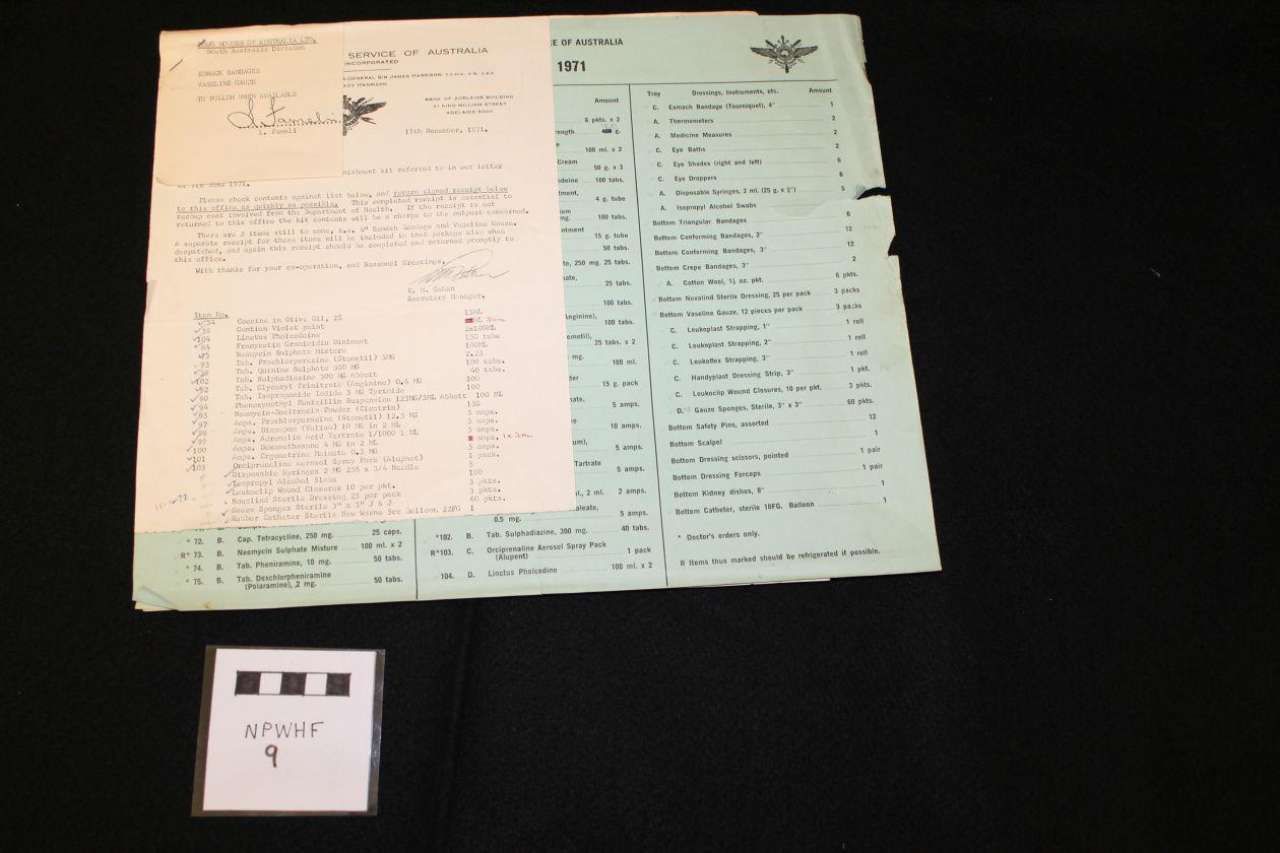 Open booklet and small card on a dark background
