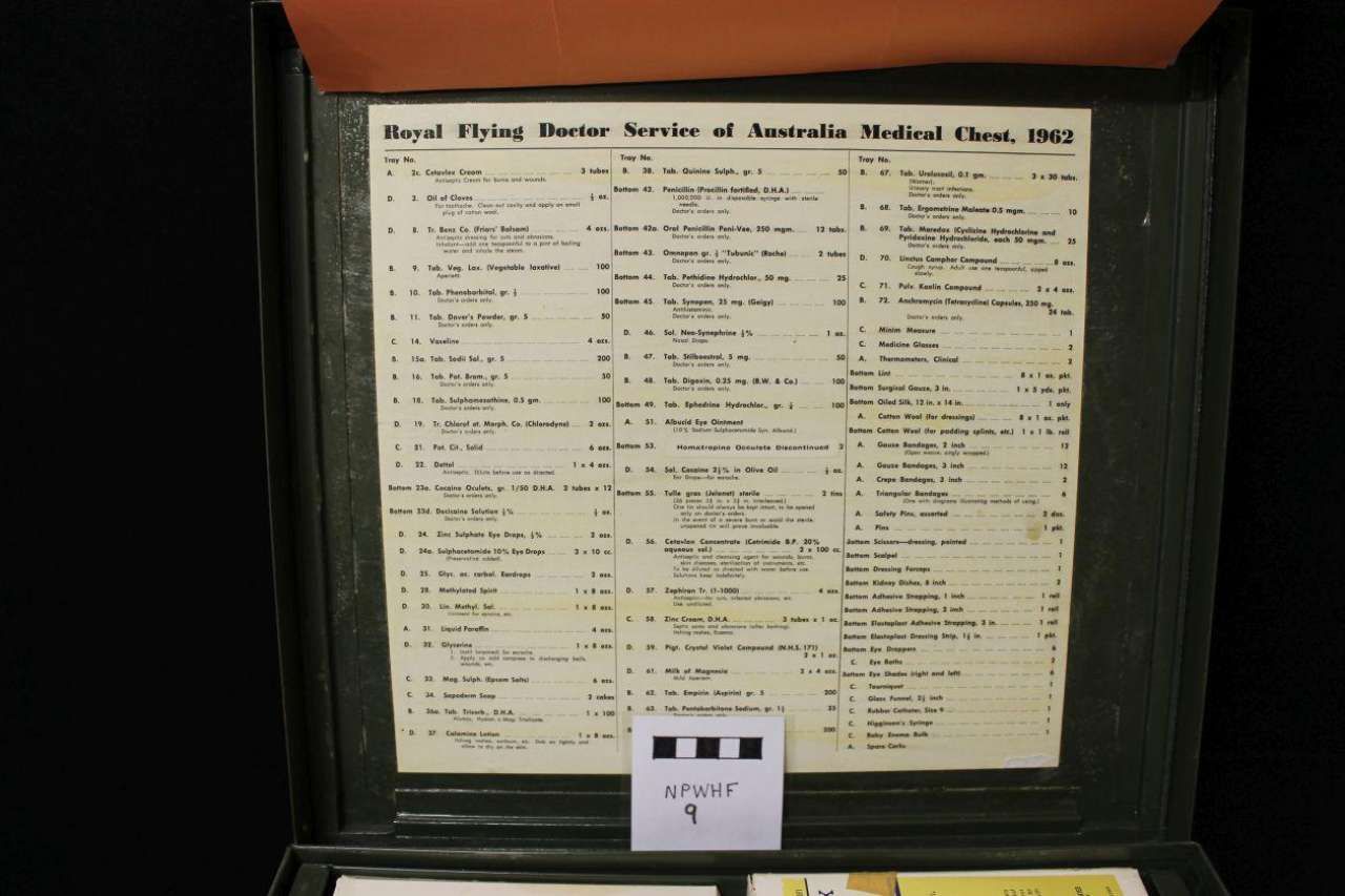 Framed vintage newspaper clipping on a wall, with a small label card beneath it.