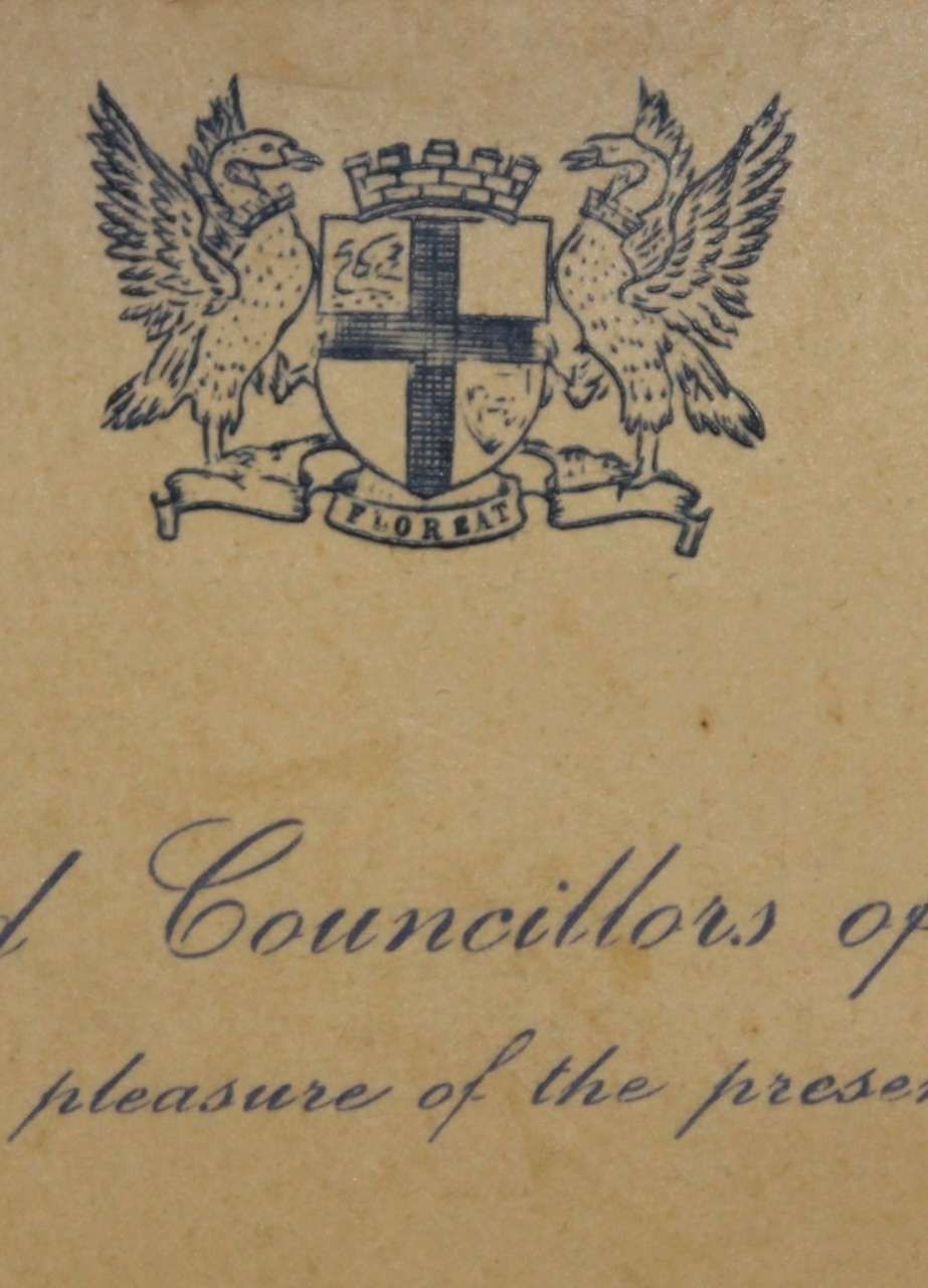 British royal coat of arms on a faded document with cursive text underneath