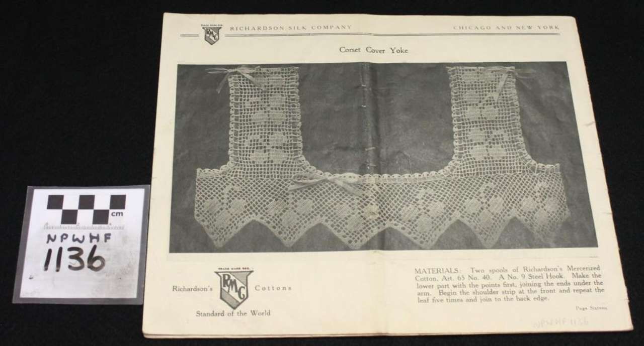 Black-and-white photo of a framed textile or tapestry with two vertical panels and a checkerboard label beside it