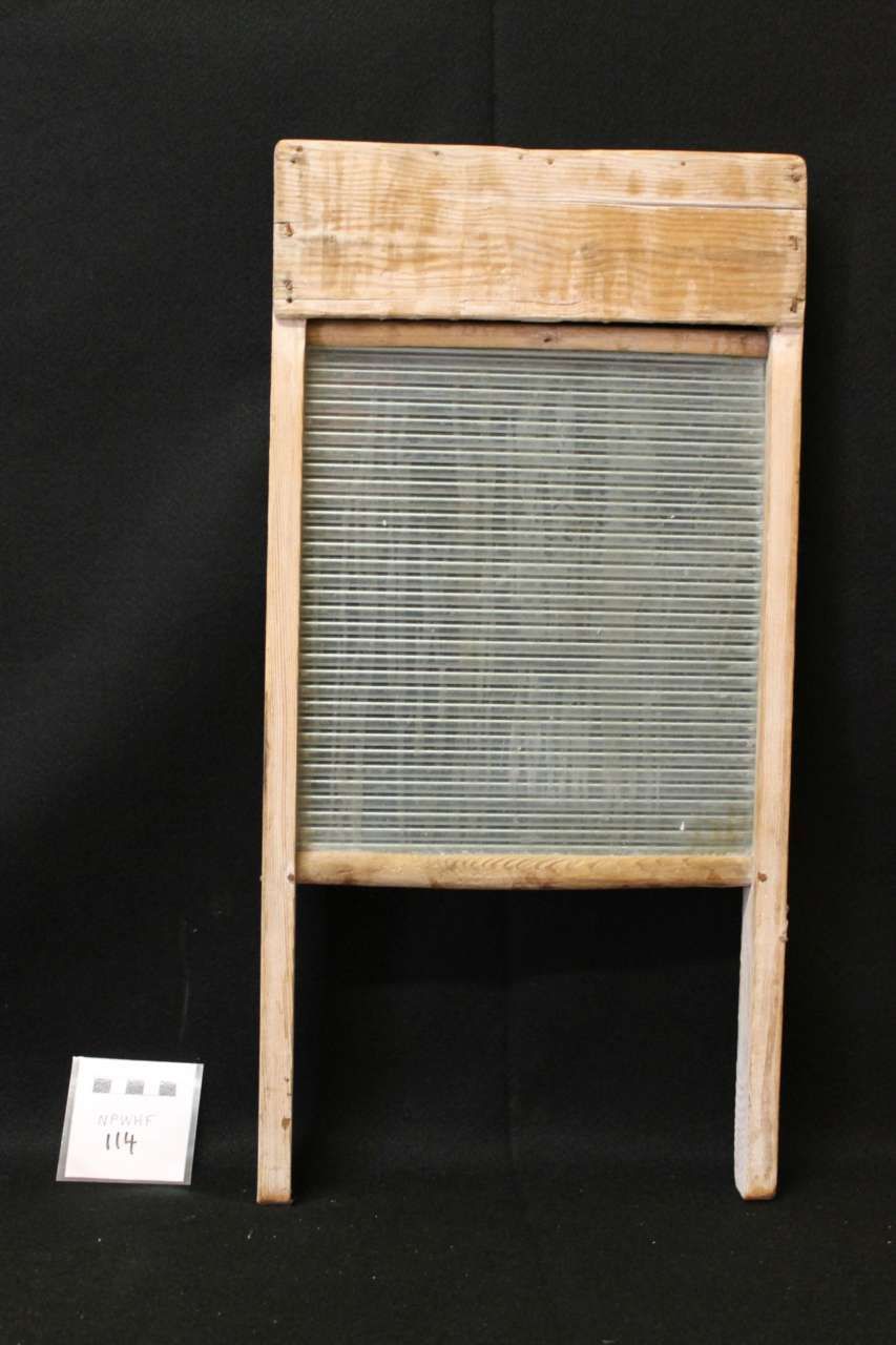Wooden chair with a woven gray seat and back on a black background
