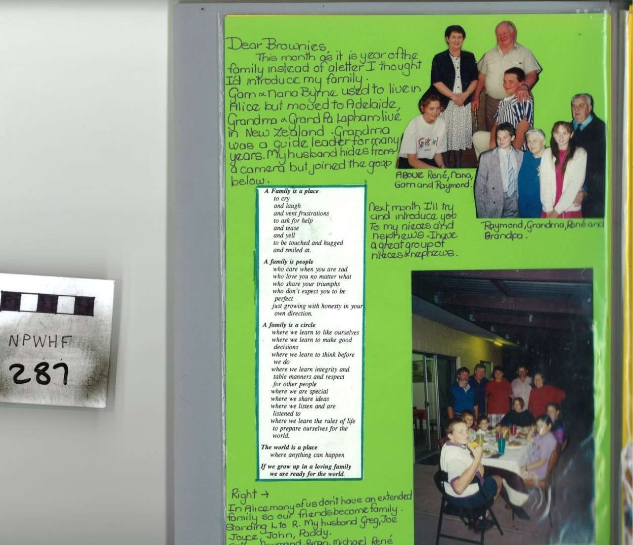 Green poster board with photos, handwritten notes, and a checklist on a wall next to a numbered paper sign.