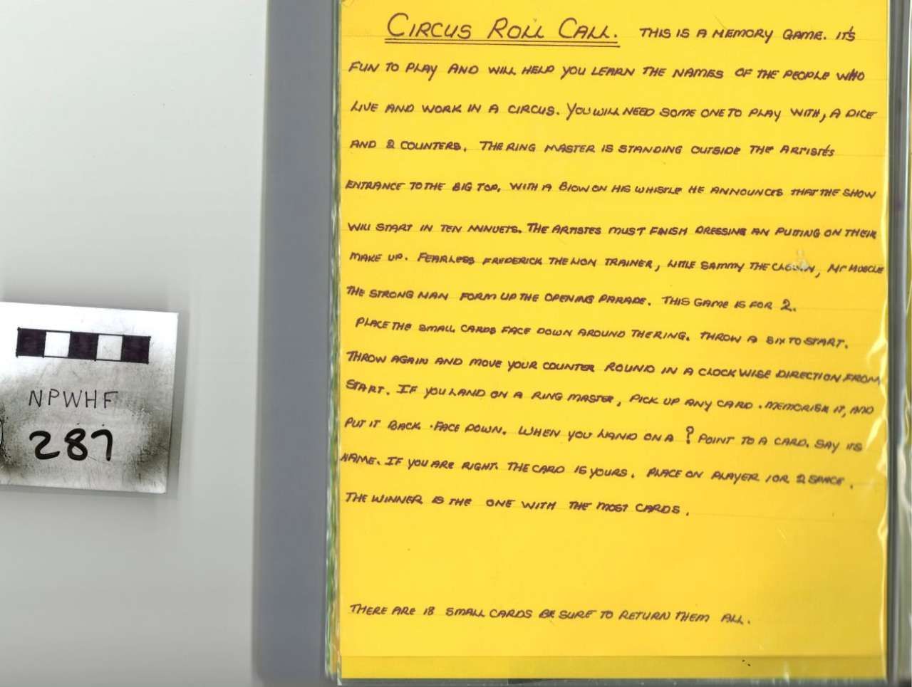 Yellow flyer on gray wall beside a small black-and-white sign showing number 281.