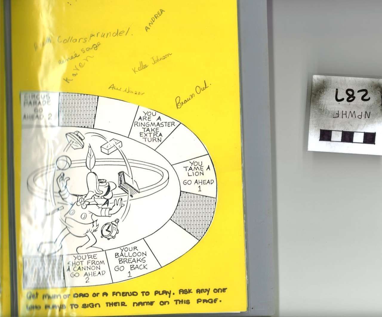 Yellow poster with a black-and-white cartoon diagram; small numbered sign on the wall beside it.