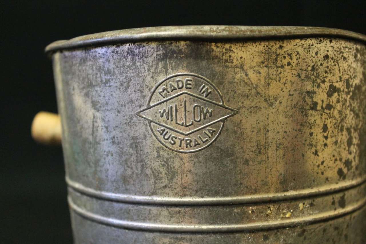 Close-up of a weathered metal bucket with a 