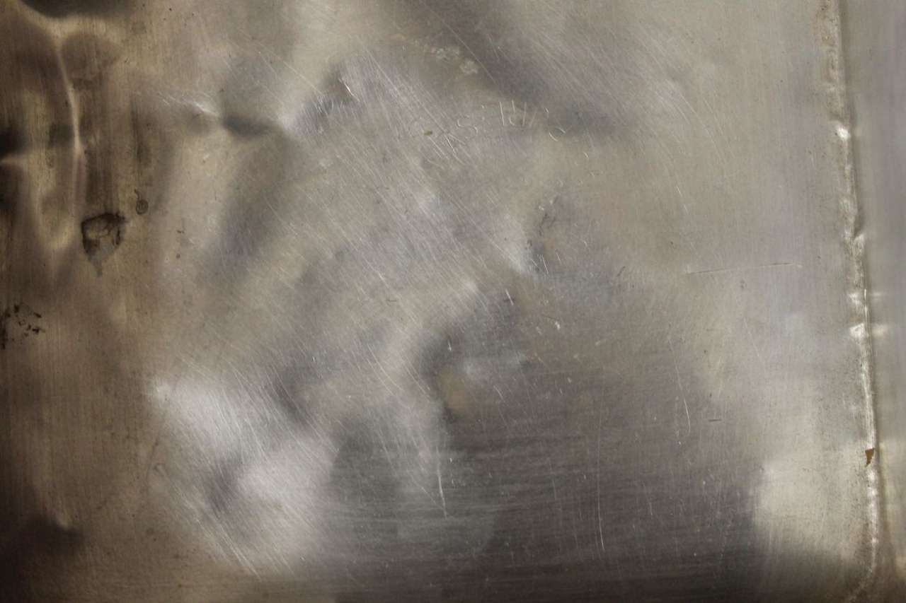 Close-up of a gray, wrinkled fabric surface with a vertical seam on the right side