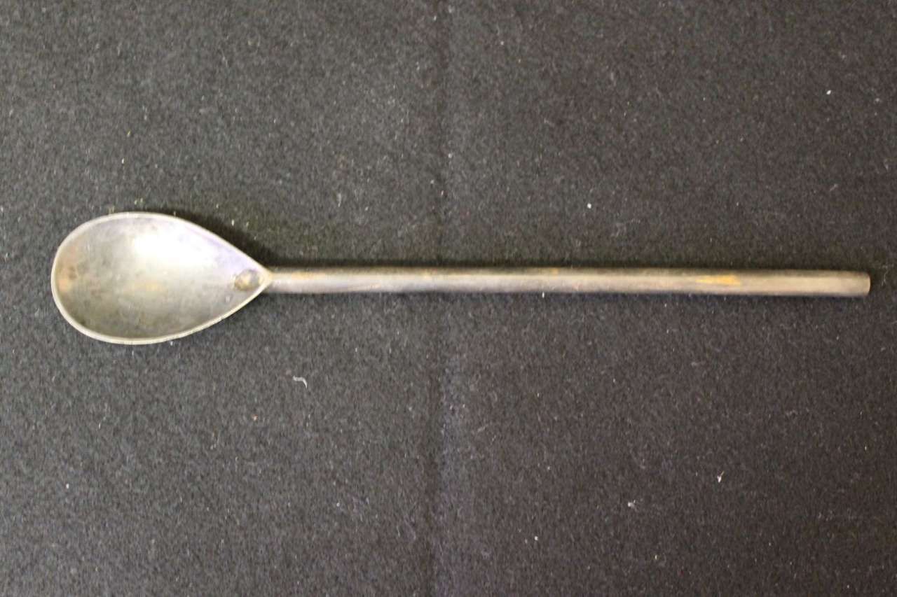 Silver spoon on a dark fabric background