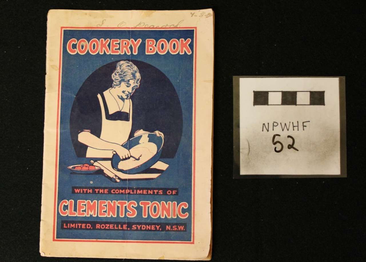 Vintage “Cookery Book” cover beside a small labeled card on a black background