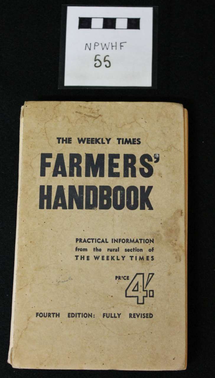 Vintage beige “The Weekly Times Farmers’ Handbook” booklet beside a small numbered archive card on a dark background