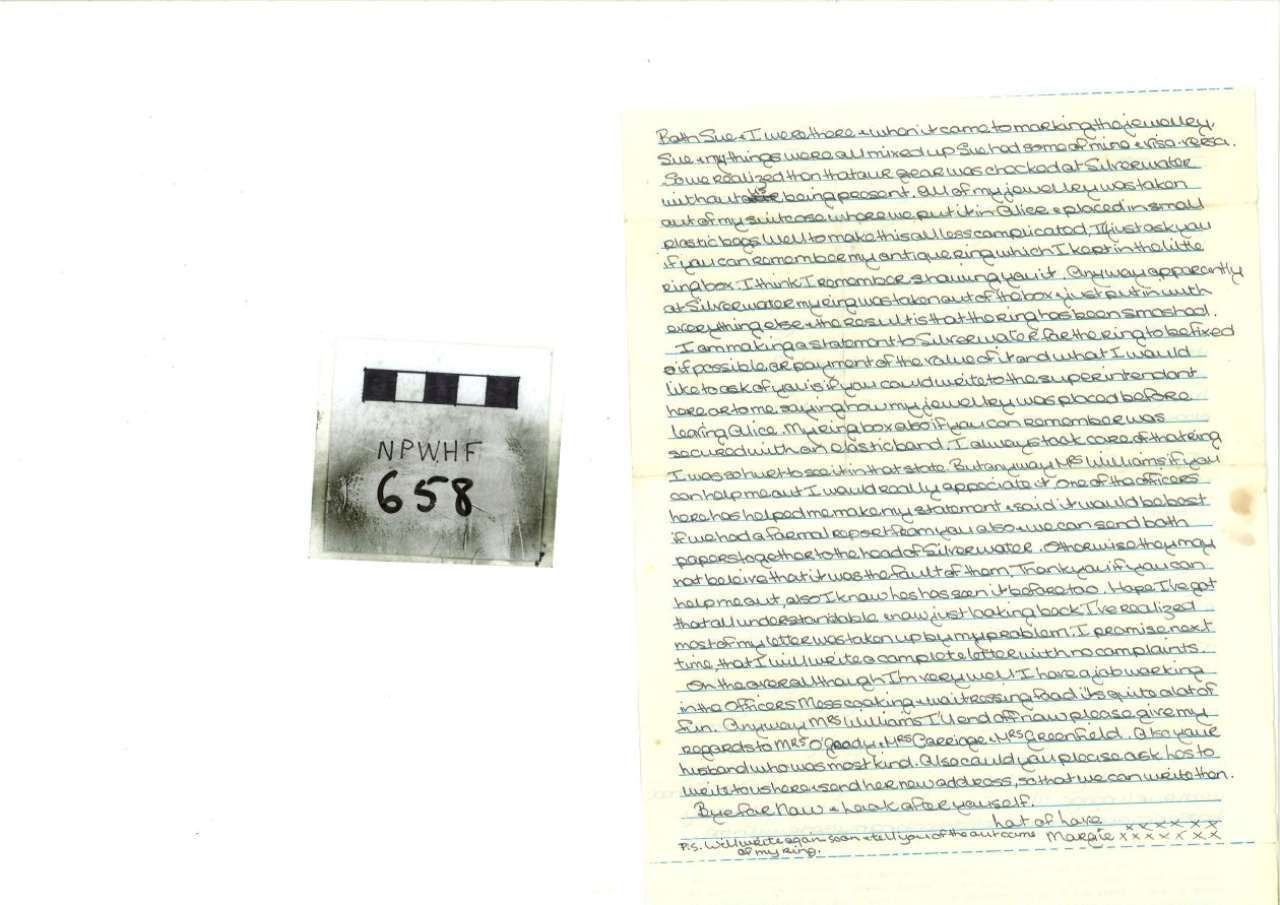 Small black-and-white object beside a page of handwritten text.