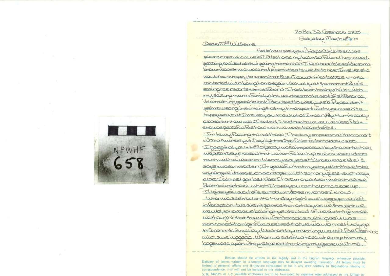 Handwritten manuscript page beside a small labeled film canister reading “A.I.T. 656”
