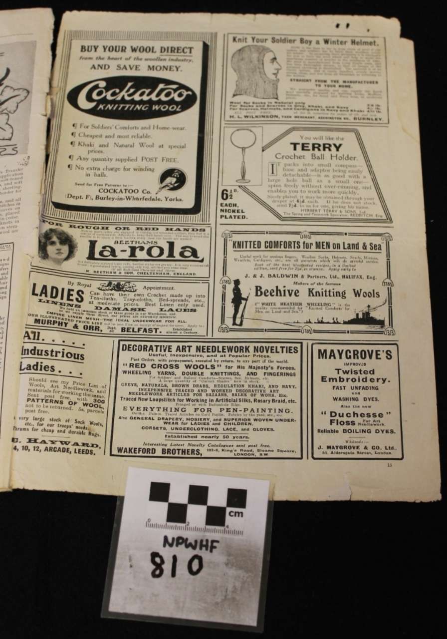 Black-and-white photo of a page filled with vintage advertisements and a small numbered label at the bottom.