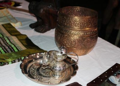 A table with a picture of a man and a bowl on it