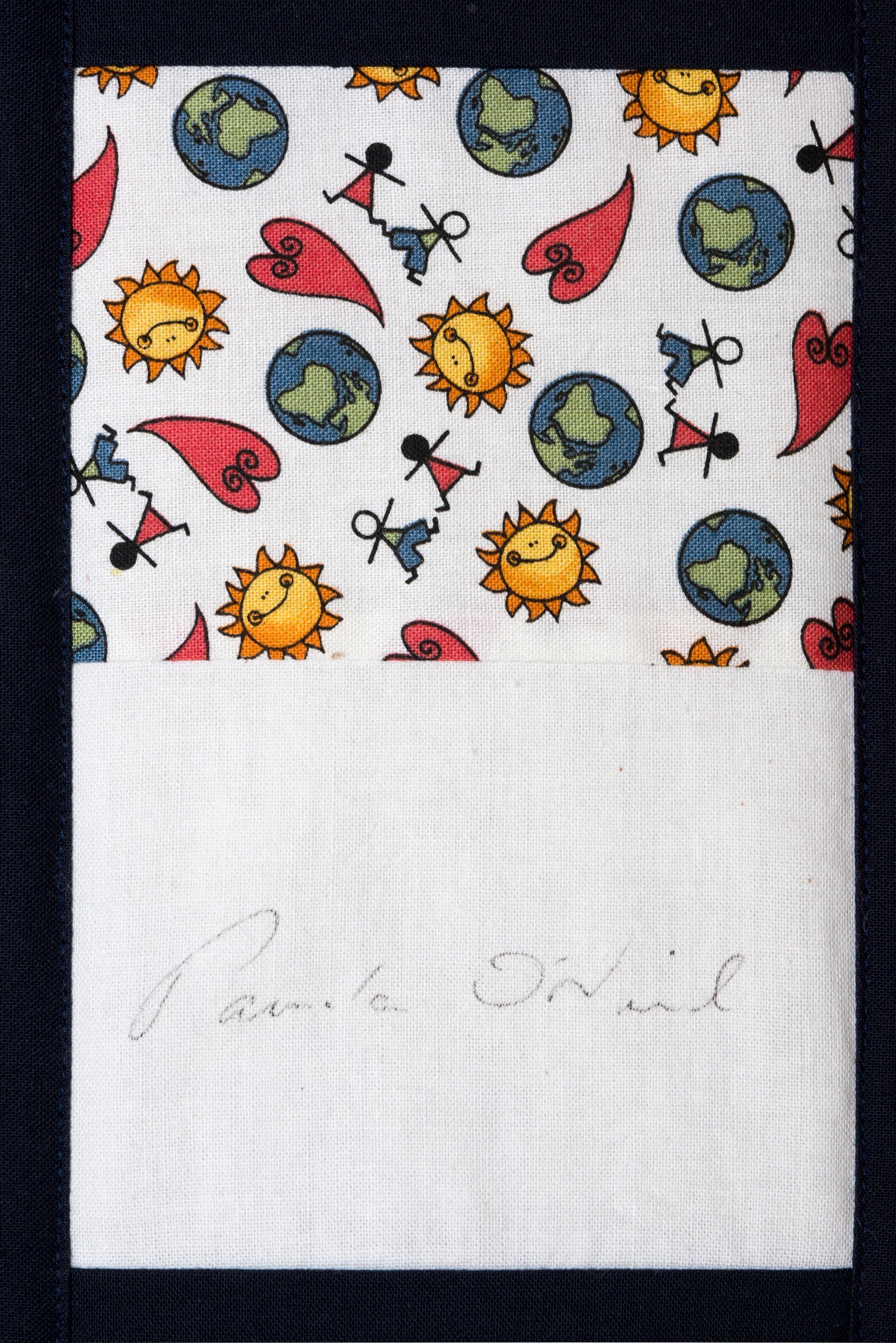 White notepad with colorful sun, earth, and red leaf doodles on top and faint handwritten note below