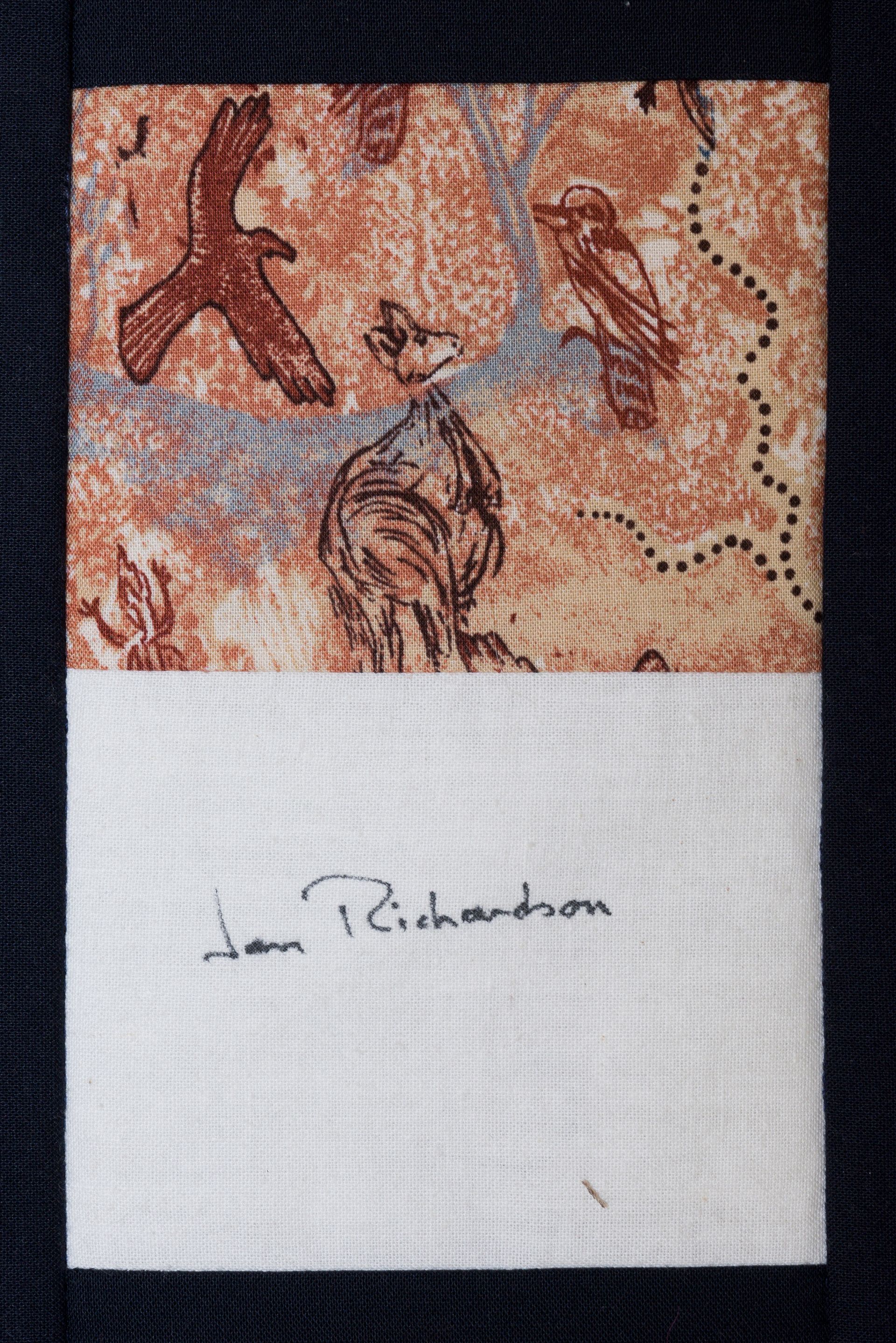 Textured fabric with brown and blue abstract design above a white signed section