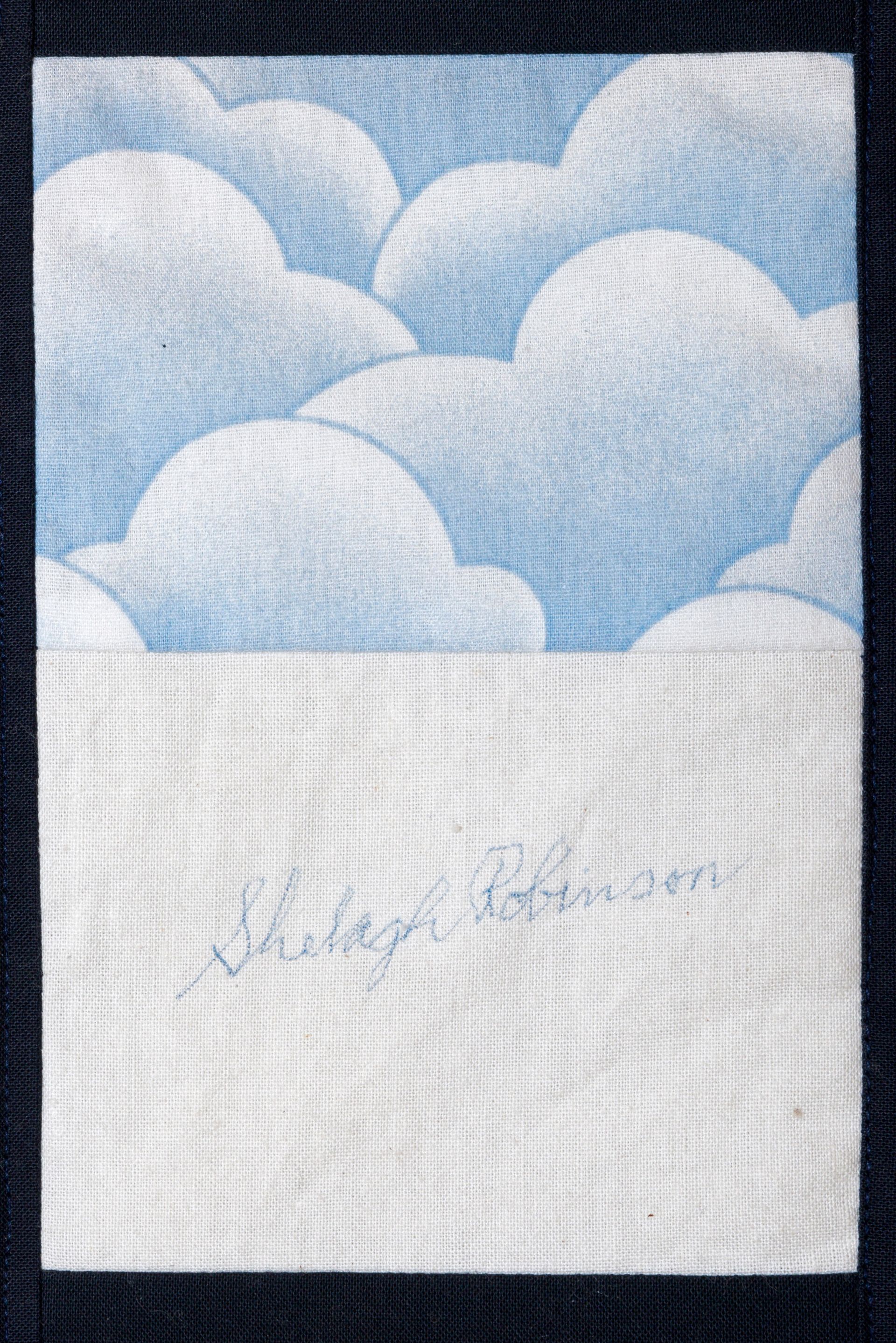 Blue sky with fluffy clouds above a blank white area with faint handwritten text.