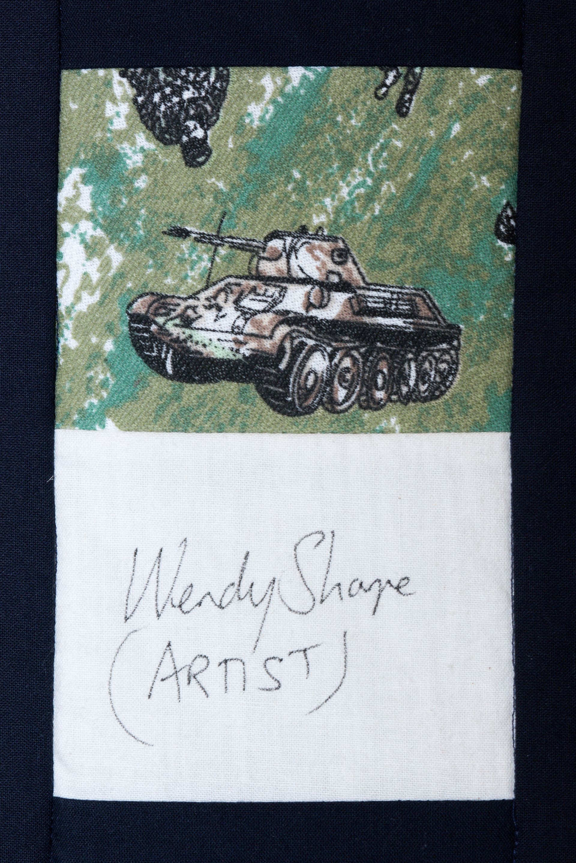 Hand-drawn tank on green background with handwritten note below saying “Heavy Strage (ARTIST)”