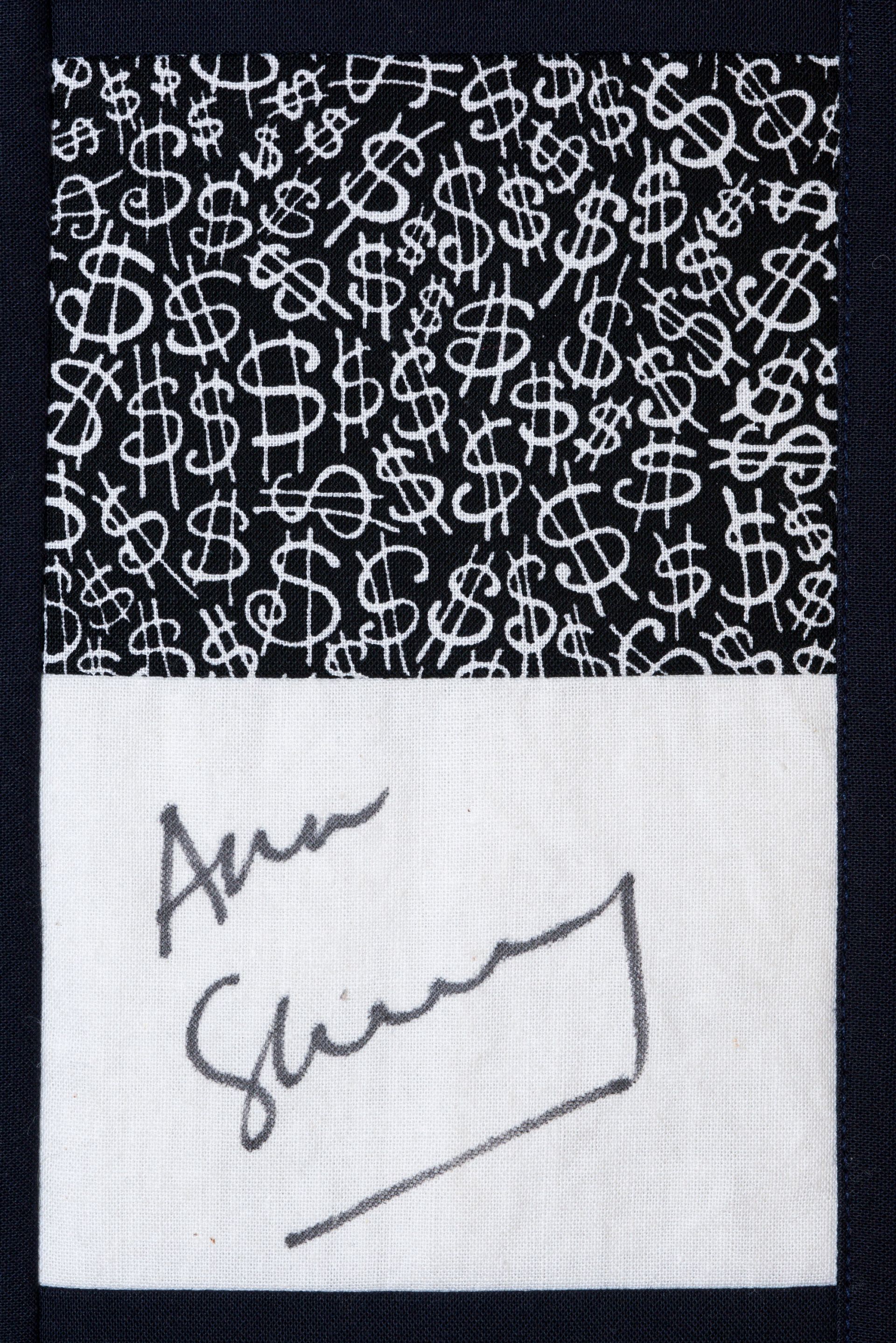 Black-and-white patterned card with a handwritten signature on a white section.