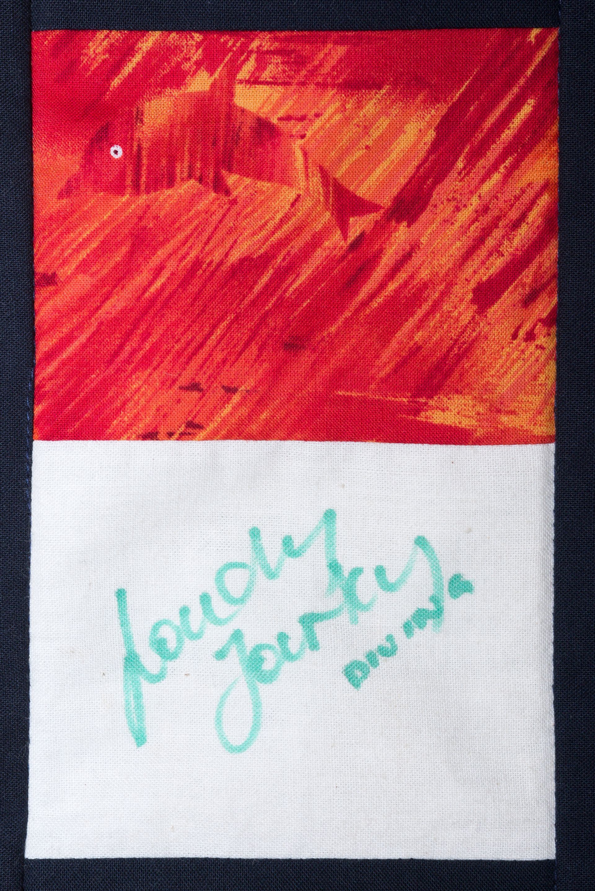 Red-and-white card with teal handwritten “touch gently” text