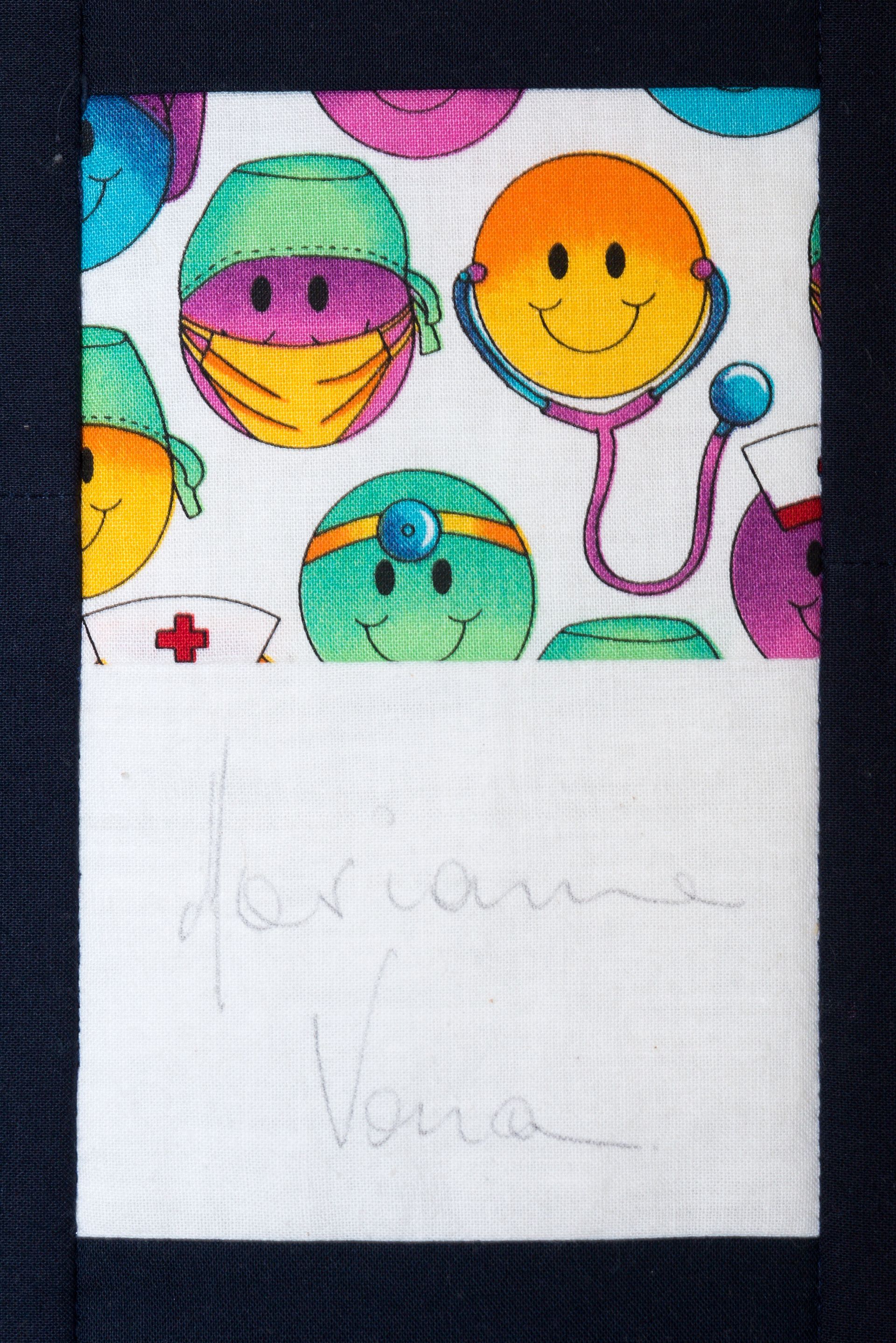 Colorful cartoon faces above a white panel with faint pencil writing and a small red cross
