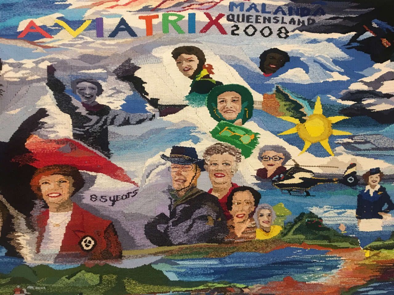 Mural with colorful portraits, mountains, sun, and the words “MATRIX MALAYSIA QUEENSLAND 2008.”