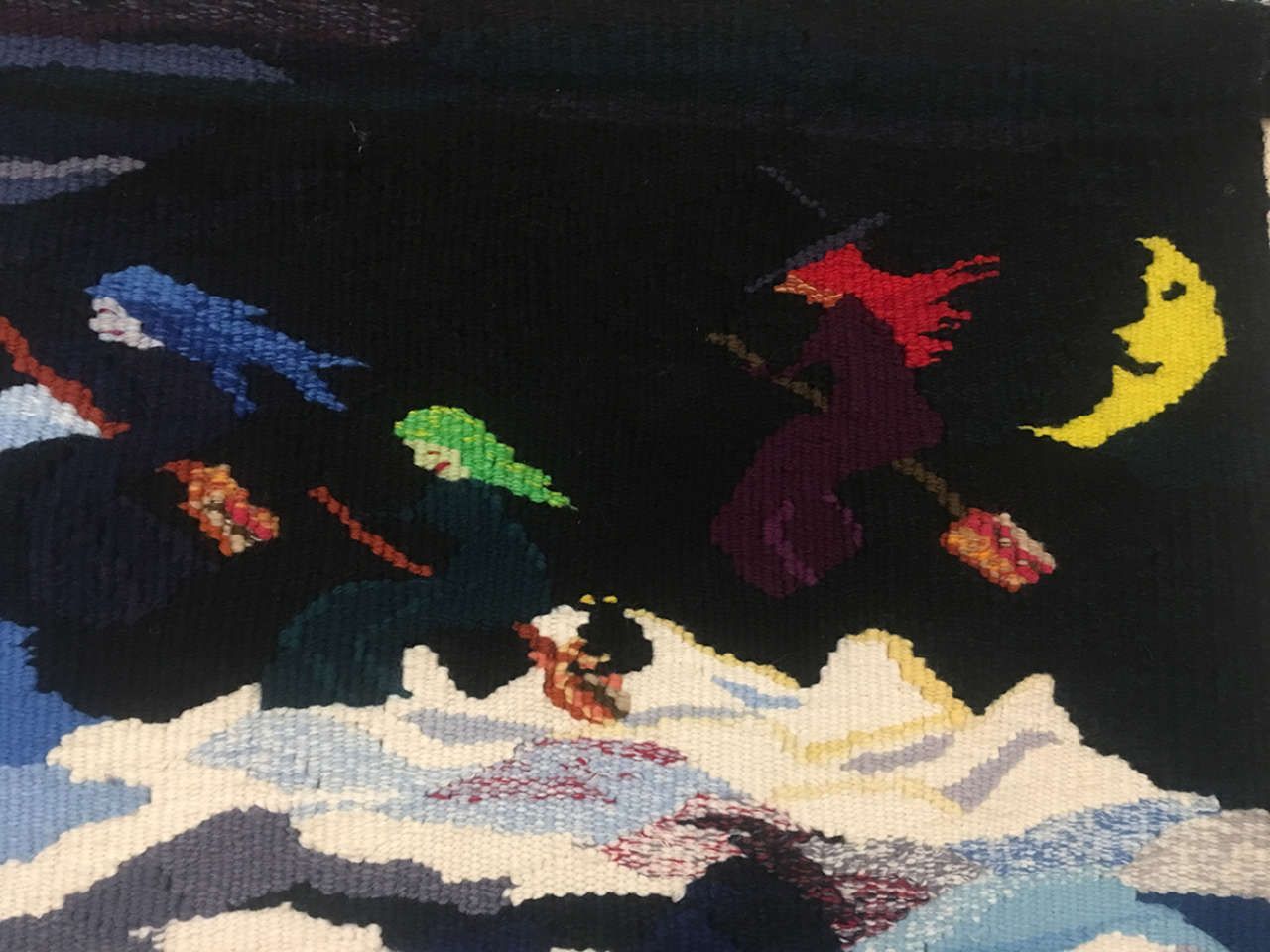 Colorful birds flying over snowy mountains under a dark sky